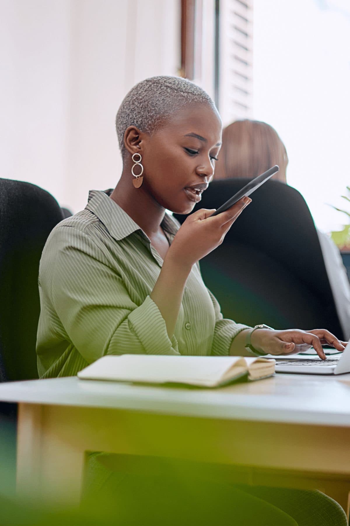 Business owner working between phone and laptop